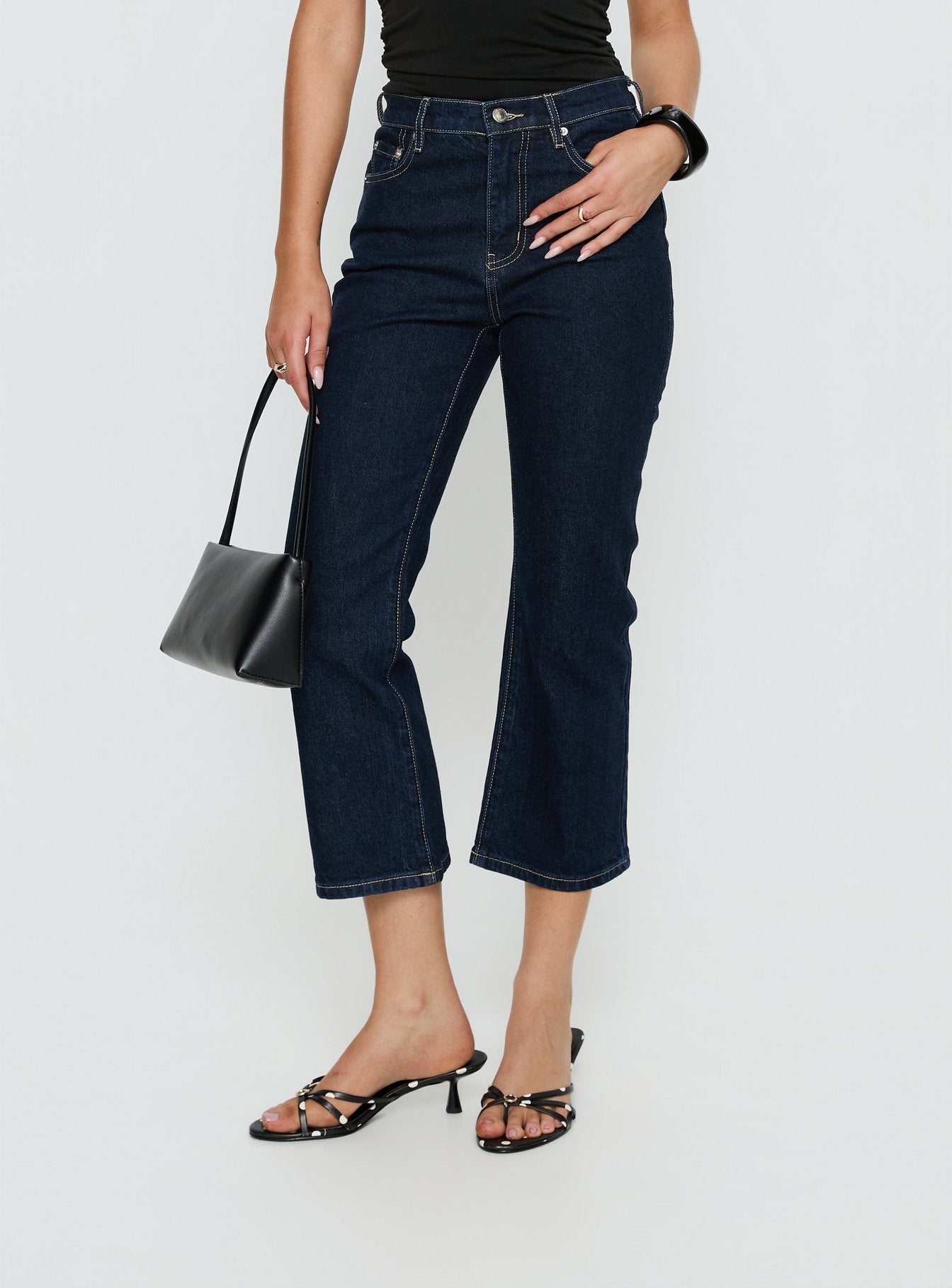 front view of model wearing Princess Polly Cindee High Rise Cropped Jeans Raw Indigo High Rise Jeans 