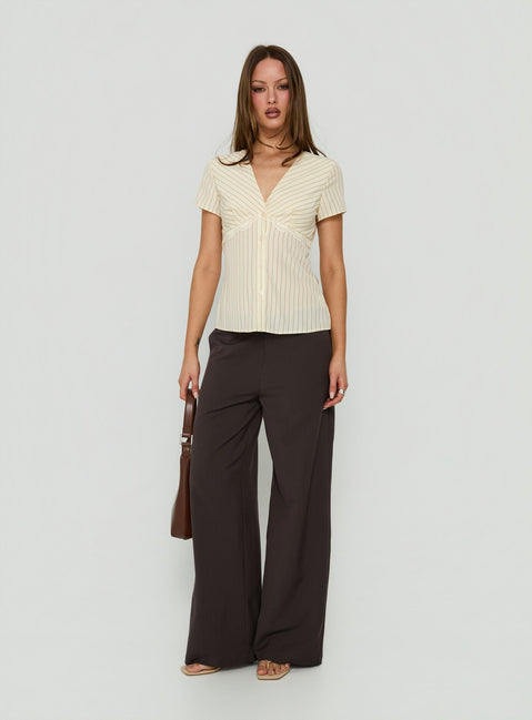 Discover Mericana Low Rise Wide Leg Pants in Brown womens regular pants with low-rise waist side view of model wearing Princess Polly