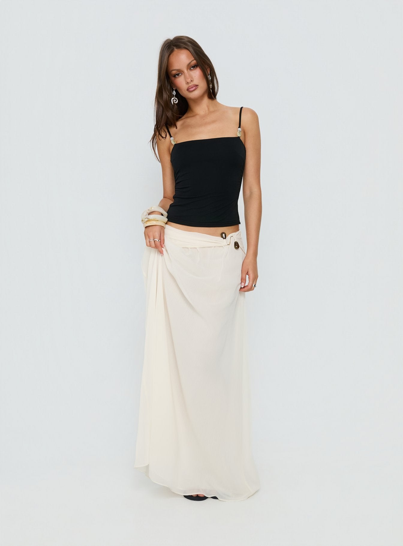   side view of model wearing Princess Polly Kaledia Chiffon Draped Maxi Skirt Cream Maxi Skirts 