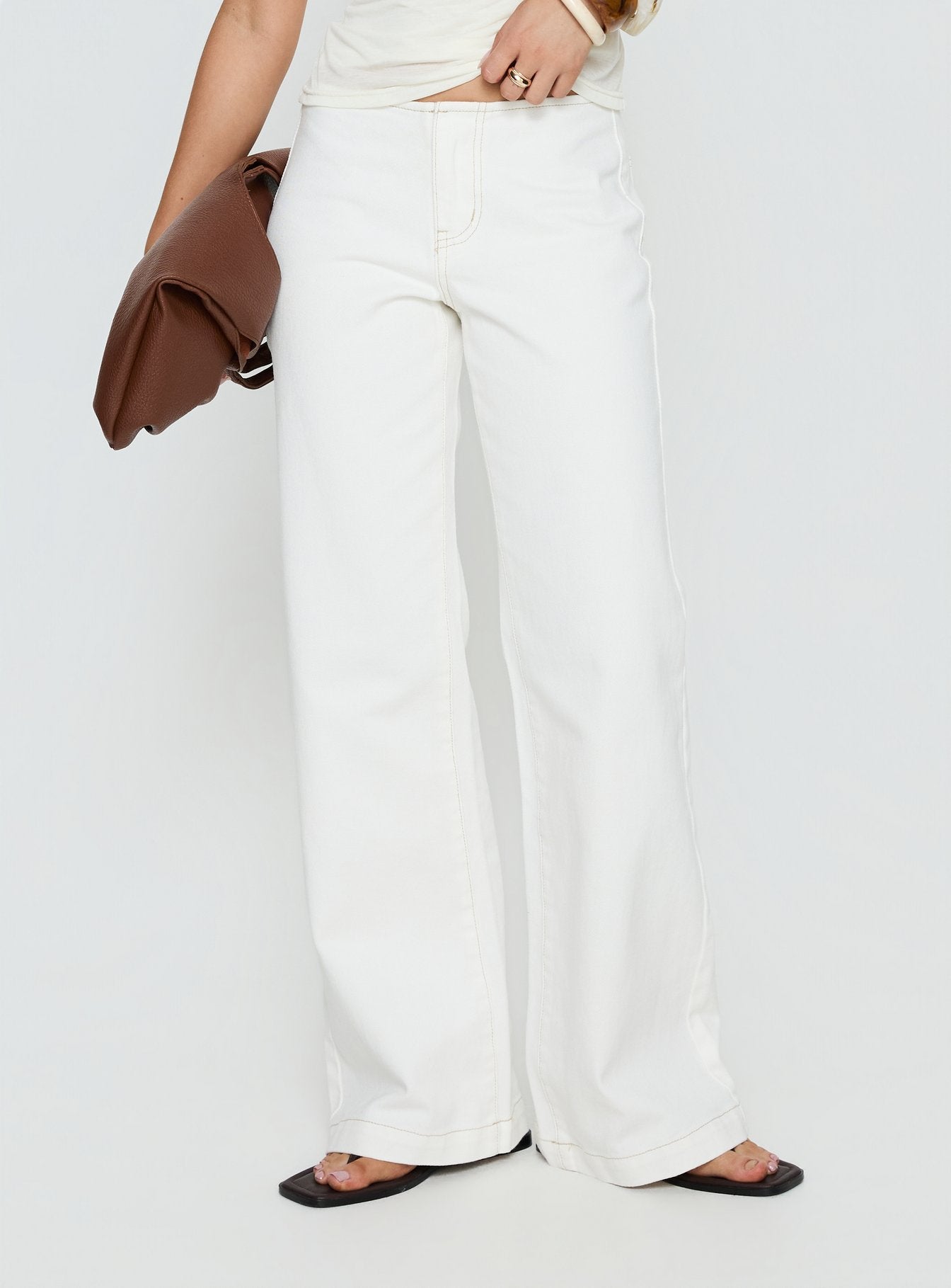 side view of model wearing Princess Polly Buenos No Waist Low Rise Straight Leg Jeans White Mid Rise Jeans 