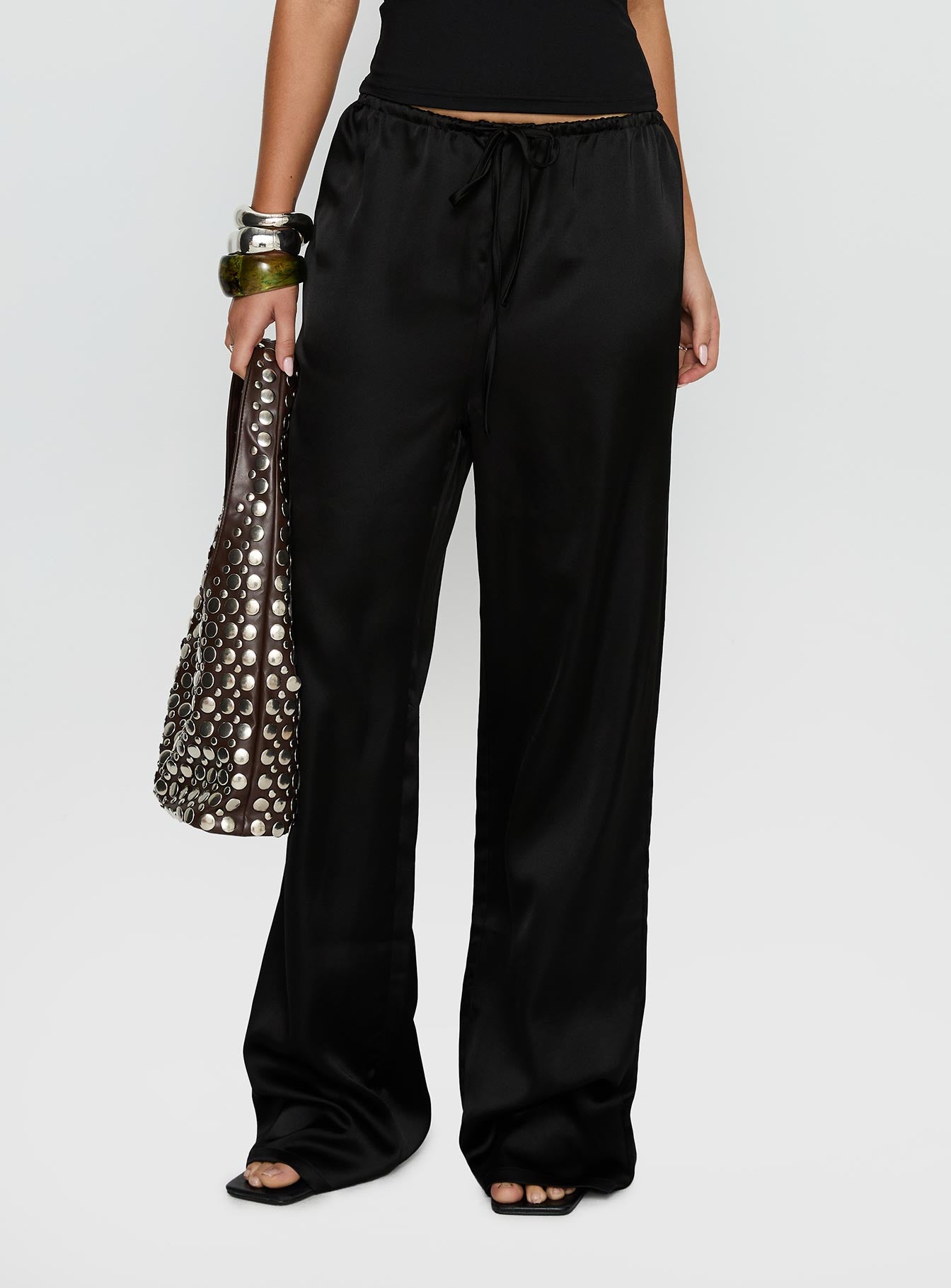 side view of model wearing Princess Polly Soulstar Satin Pants Black High Rise Pants 