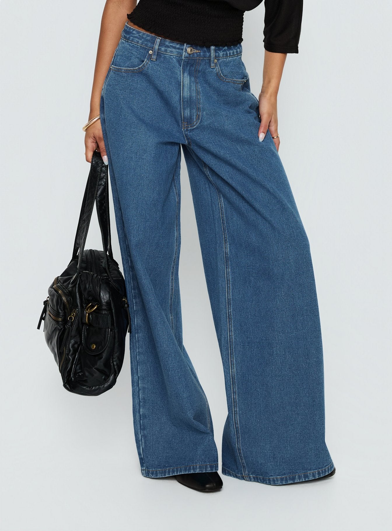 front view of model wearing Princess Polly Naylor Mid Rise Wide Leg Jeans Mid Blue Wash Mid Rise Jeans 