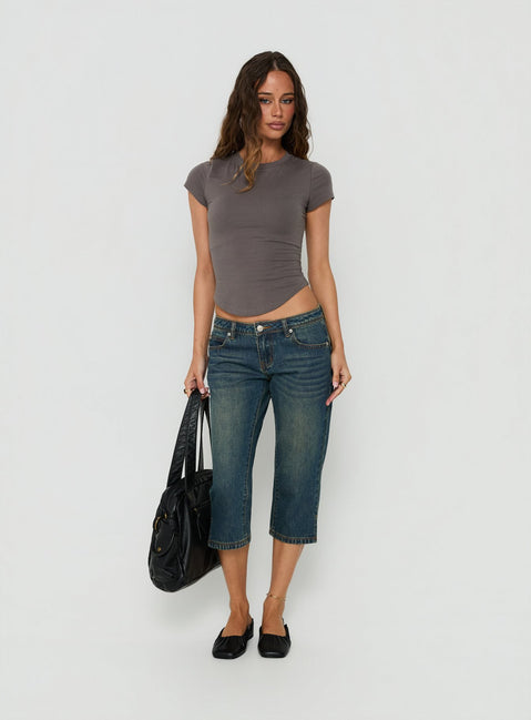 Showcasing the Ceilea Ultra Low Rise Denim Capri Pants Dirty Blue in womens regular pants with low-rise waist front view of model wearing Princess Polly