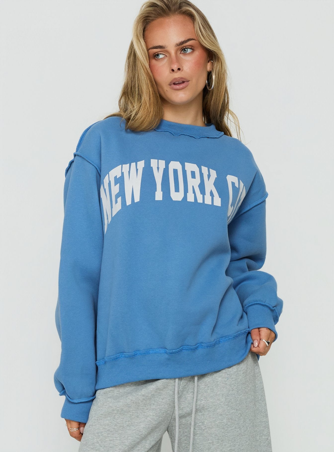 Discover the When In New York City Oversized Jumper Blue womens jumper with long fit detail view of model wearing Princess Polly