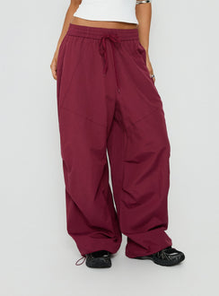 Featuring the Mankind Baggy Cargo Pants Red womens-regular-pants in mid-rise maroon detail view of model wearing Princess Polly
