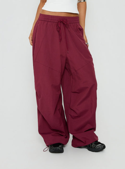 Featuring the Mankind Baggy Cargo Pants Red womens-regular-pants in mid-rise maroon detail view of model wearing Princess Polly