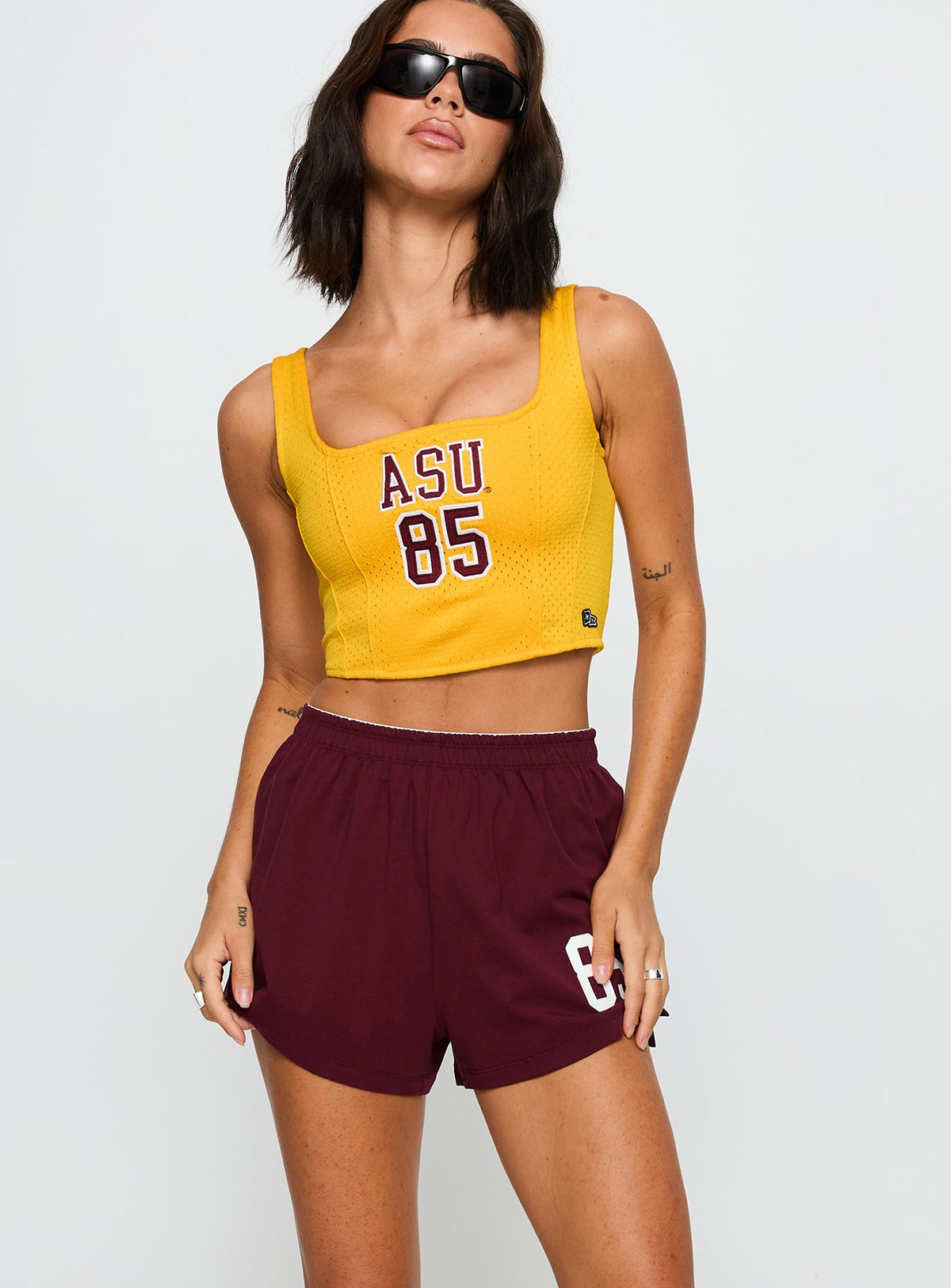 front view of model wearing Princess Polly ASU Soffee Shorts Maroon High Waisted Shorts 