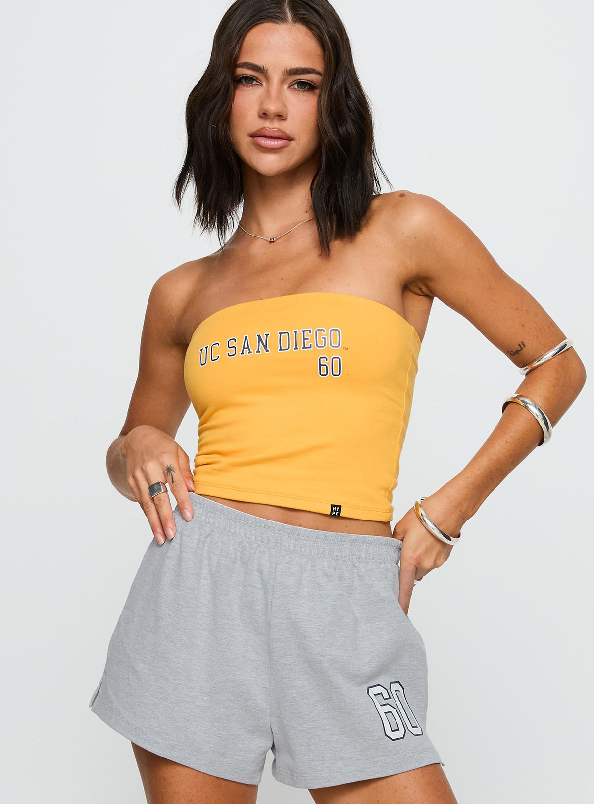 back view of model wearing Princess Polly UC San Diego Tube Top Gold Sleeveless straight 