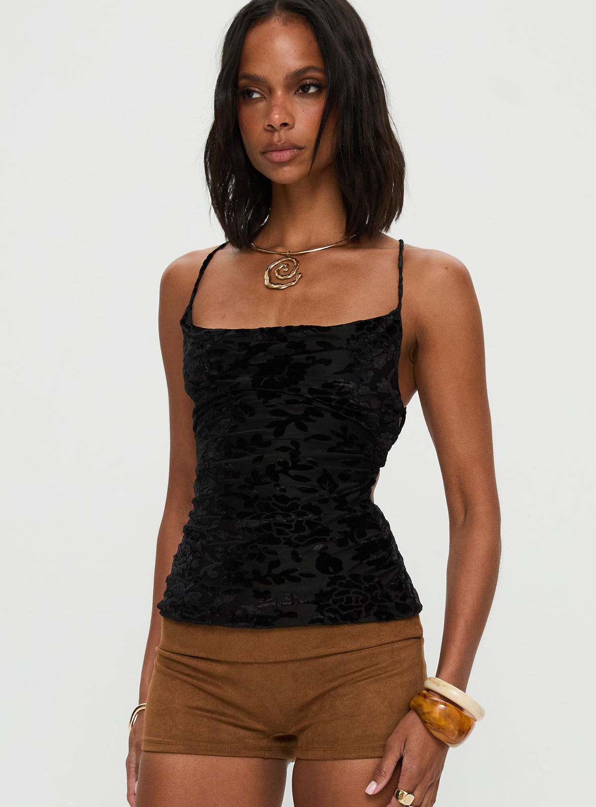 side view of model wearing Princess Polly Celena Halter Top Black Sleeveless Cowl 