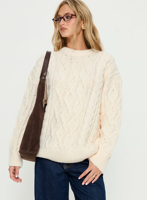 Showcasing the Rorey Cable Knit Crew Neck Sweater White womens-jumpers with oversized fit in long length side view of model wearing Princess Polly