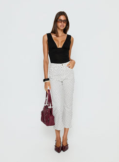 side view of model wearing Princess Polly Cindee High Rise Cropped Jeans White Polka Dot High Rise Jeans 