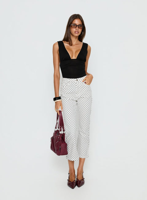 side view of model wearing Princess Polly Cindee High Rise Cropped Jeans White Polka Dot High Rise Jeans 
