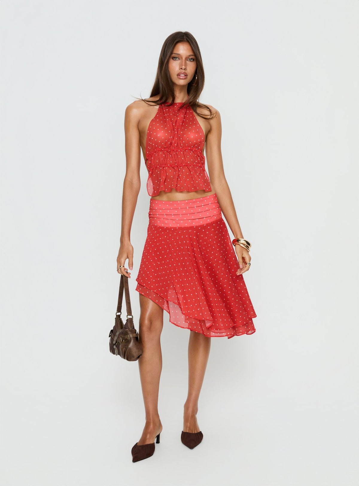  side view of model wearing Princess Polly Legacy Midi Skirt Tomato Polka 