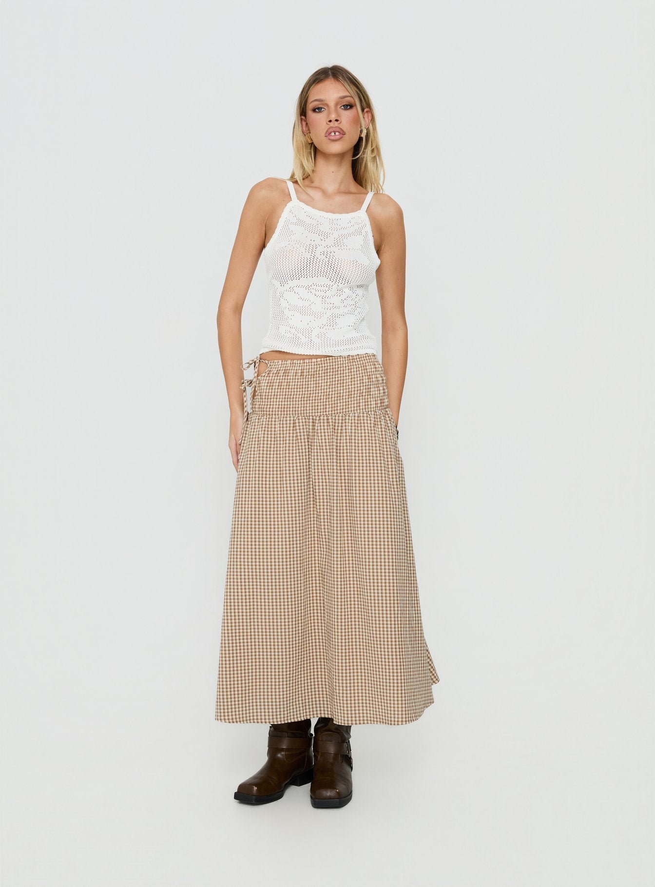 Showcasing the Vence Ruched Maxi Skirt Brown Gingham in womens-skirts with checkered print and relaxed a-line shape front view of model wearing Princess Polly