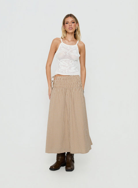 Showcasing the Vence Ruched Maxi Skirt Brown Gingham in womens-skirts with checkered print and relaxed a-line shape front view of model wearing Princess Polly