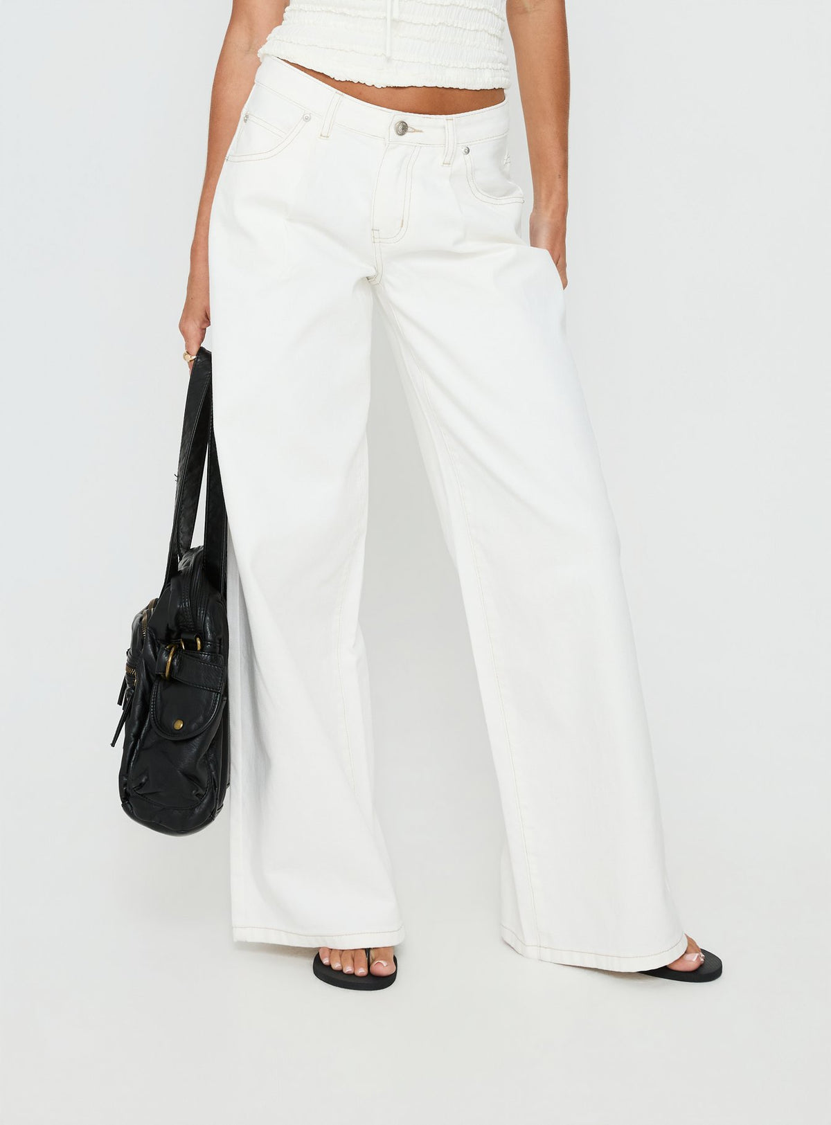 back view of model wearing Princess Polly Supercut Low Rise Baggy Pleat Jeans Cream Mid Rise Jeans Jeans 
