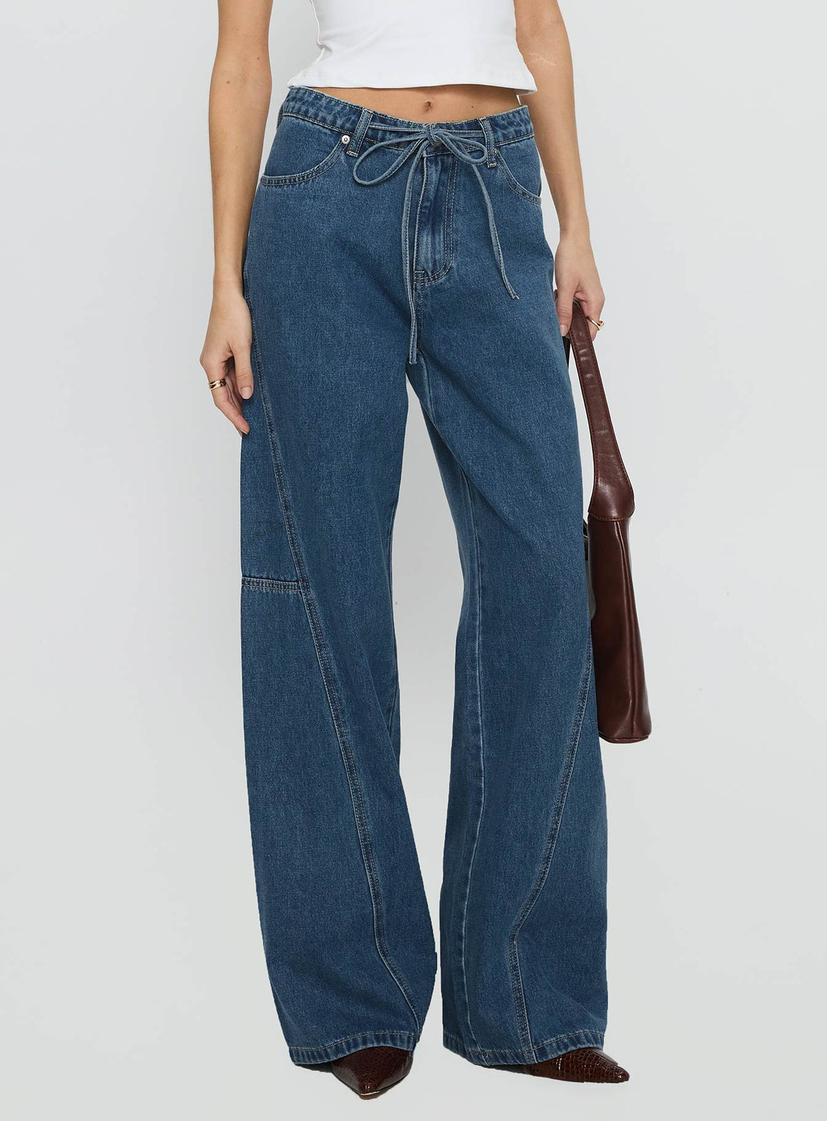 back view of model wearing Princess Polly Bruiser Mid Rise Wide Leg Jeans Mid Blue Wash Mid Rise Jeans 