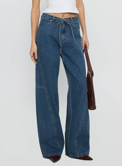 back view of model wearing Princess Polly Bruiser Mid Rise Wide Leg Jeans Mid Blue Wash Mid Rise Jeans 
