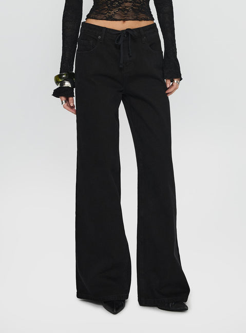 side view of model wearing Princess Polly Mellowed Out Low Rise Straight Leg Jeans Washed Black Low Rise Jeans 