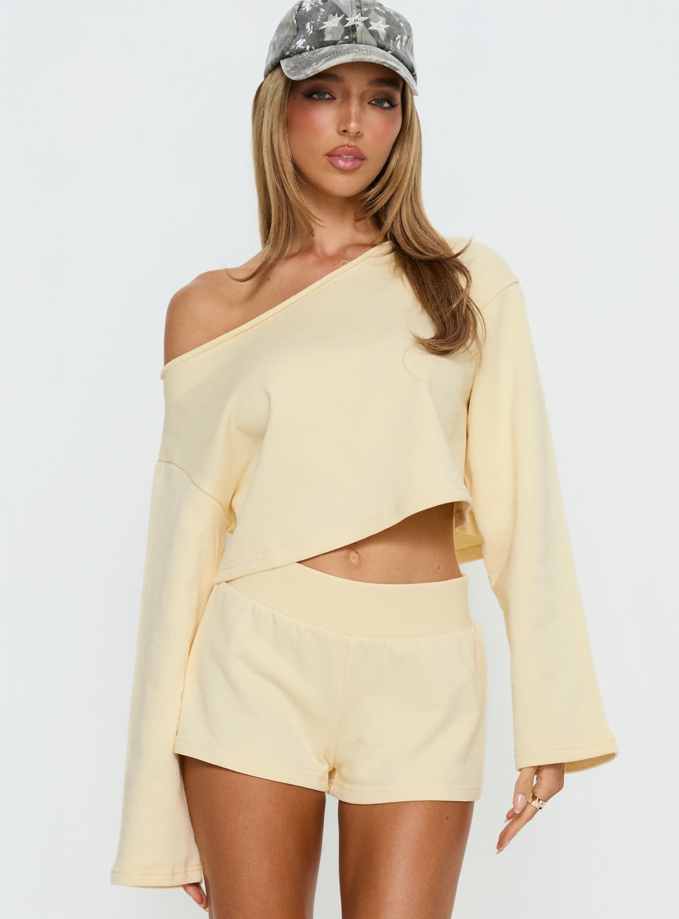 front view of model wearing Princess Polly Retreat Raw Edge Off Shoulder Jumper Buttercream cropped 