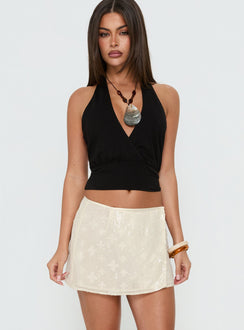 Showcasing the Brittain Wrap Mini Skirt Cream womens-skirts with mini length detail Princess Polly
