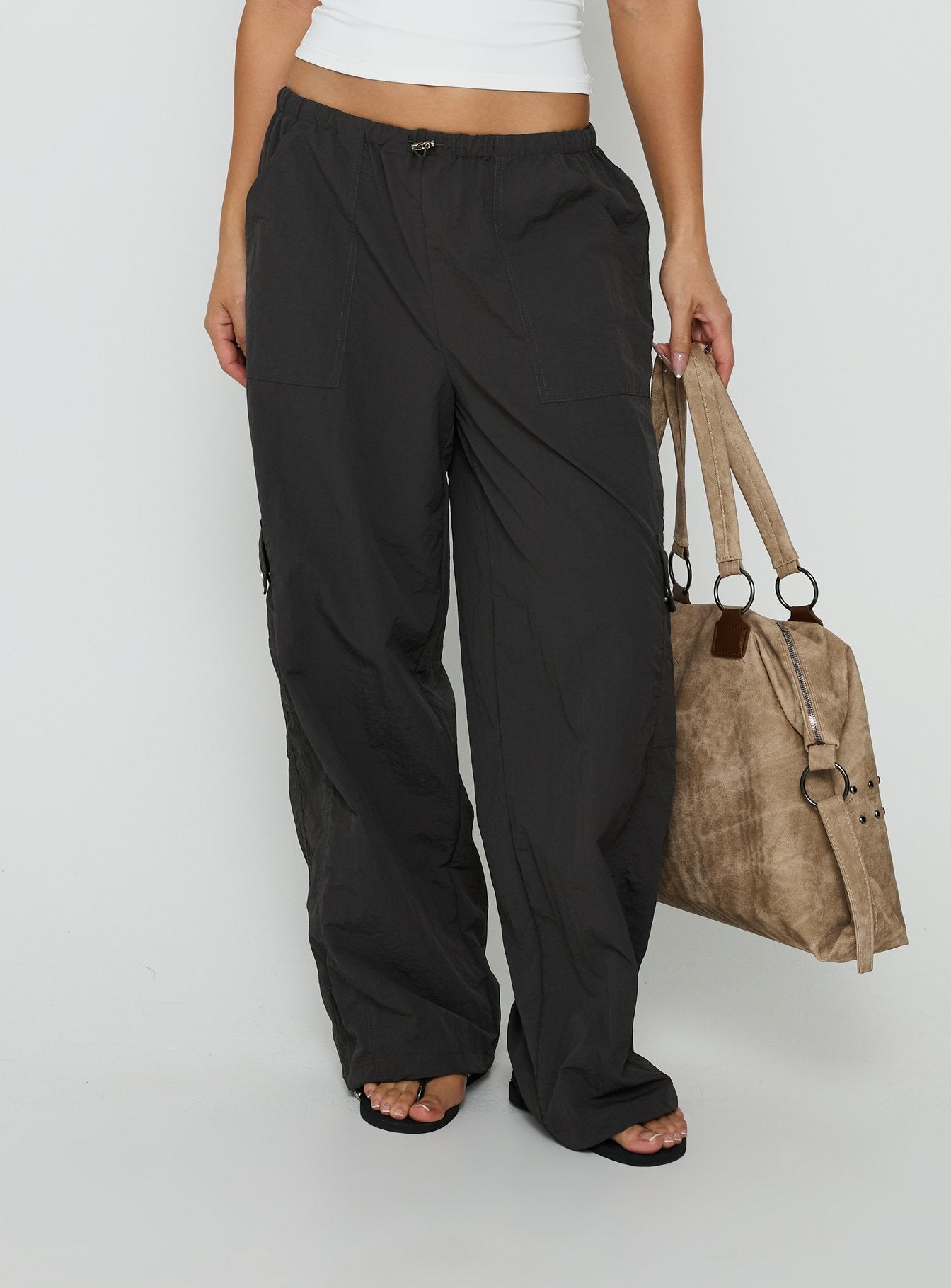 Featuring the Lost On You Parachute Cargo Pants Charcoal in mid-rise womens-regular-pants detail view of model wearing