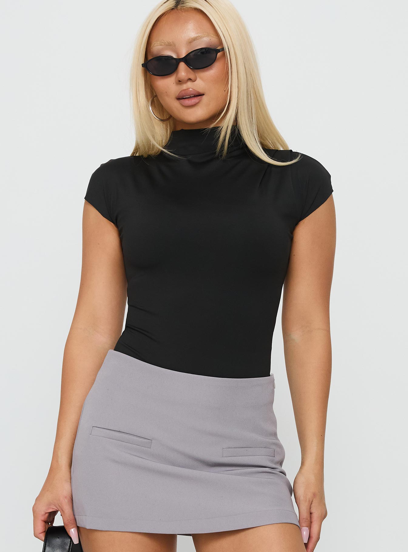 Designed with the Cailie Mock Neck Bodysuit Black womens-bodysuit featuring short sleeves front view of model wearing Princess Polly