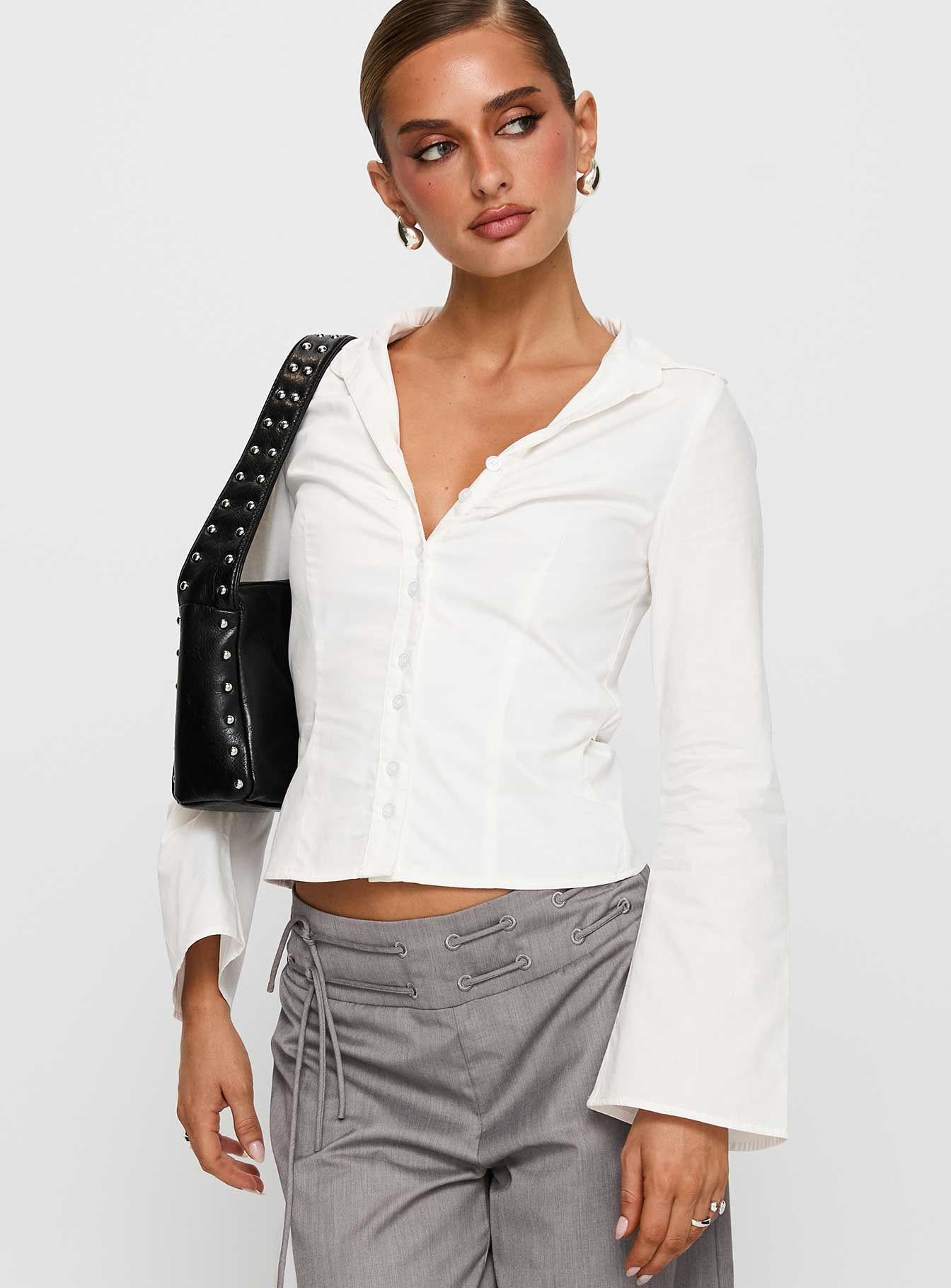 side view of model wearing Princess Polly Arianwyn Long Sleeve Shirt White Full Sleeves V-Neck 