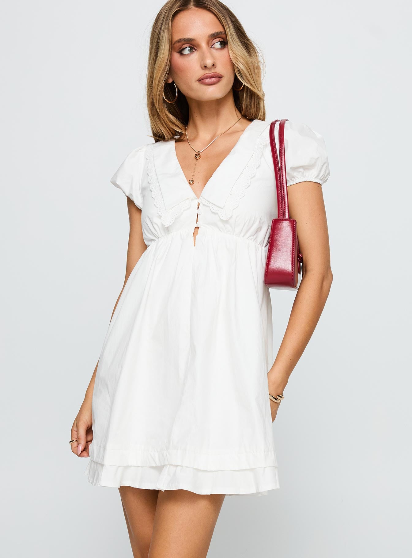 side view of model wearing Princess Polly Sailoh Puff Sleeve Baby Doll Mini Dress White V-Neck 