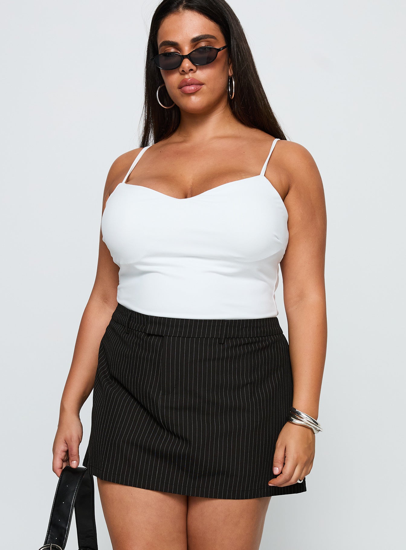 side view of model wearing Princess Polly Feminique Skort Black Stripe Curve High Waisted Shorts 