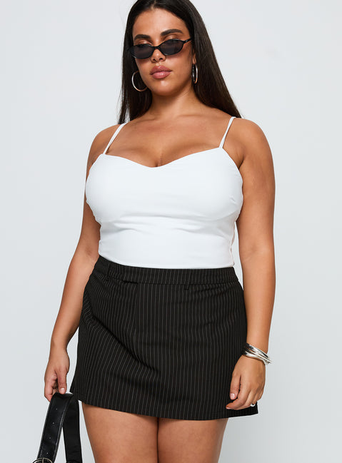 side view of model wearing Princess Polly Feminique Skort Black Stripe Curve High Waisted Shorts 