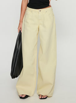 side view of model wearing Princess Polly Ramos Low Rise Wide Leg Jeans Butter Lemon Low Rise Jeans 