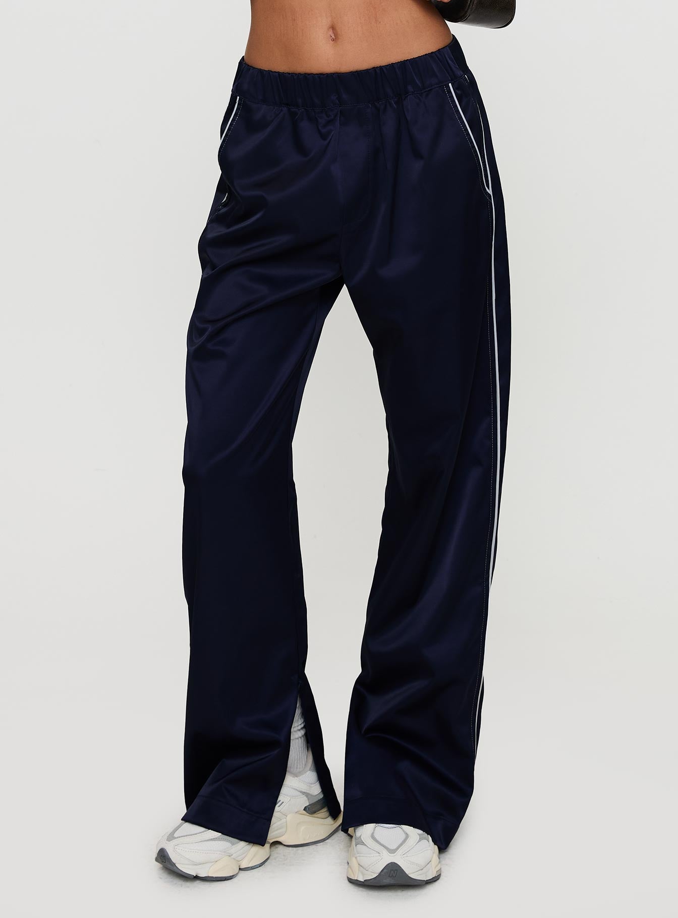 side view of model wearing Princess Polly Travalta Satin Track Pant Navy Low Rise Pants Pants 