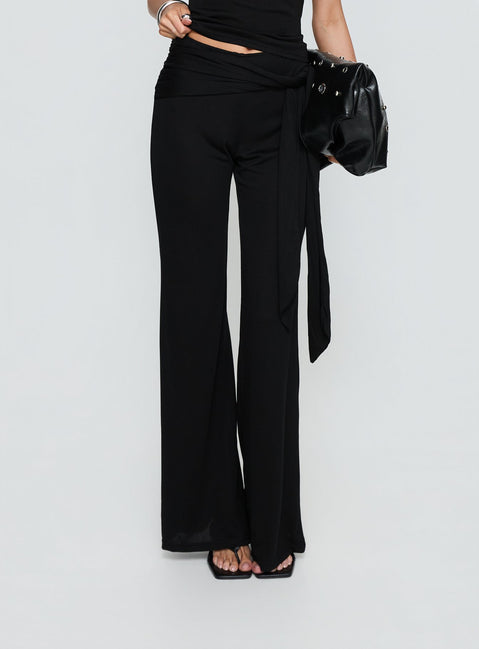 side view of model wearing Princess Polly Katiana Wrap Jersey Pants Black Mid Rise Pants 