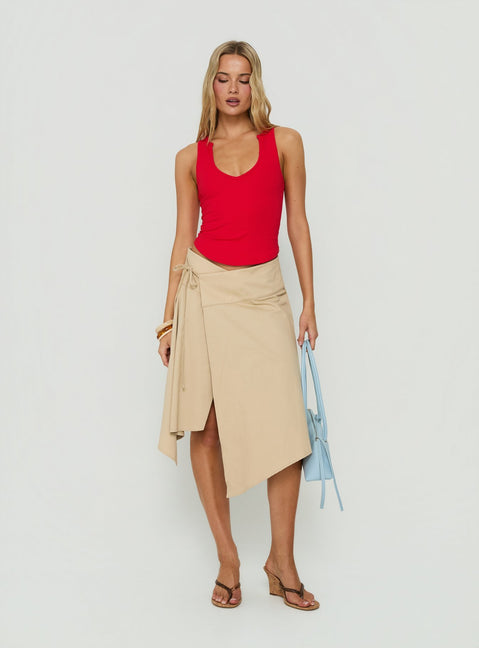 Discover the Ellainah Asymmetrical Wrap Midi Skirt Concrete in tan front view of model wearing Princess Polly