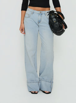 Showcasing Ezia Wide Cuff Baggy Jeans Light Blue Wash in womens-jeans with high-rise front view of model wearing Princess Polly