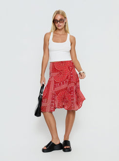   side view of model wearing Princess Polly Raenah Asymmetrical Midi Skirt Red Paisley 