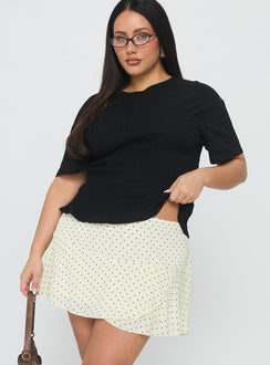   side view of model wearing Princess Polly Sonsie Mini Skirt Cream Curve 