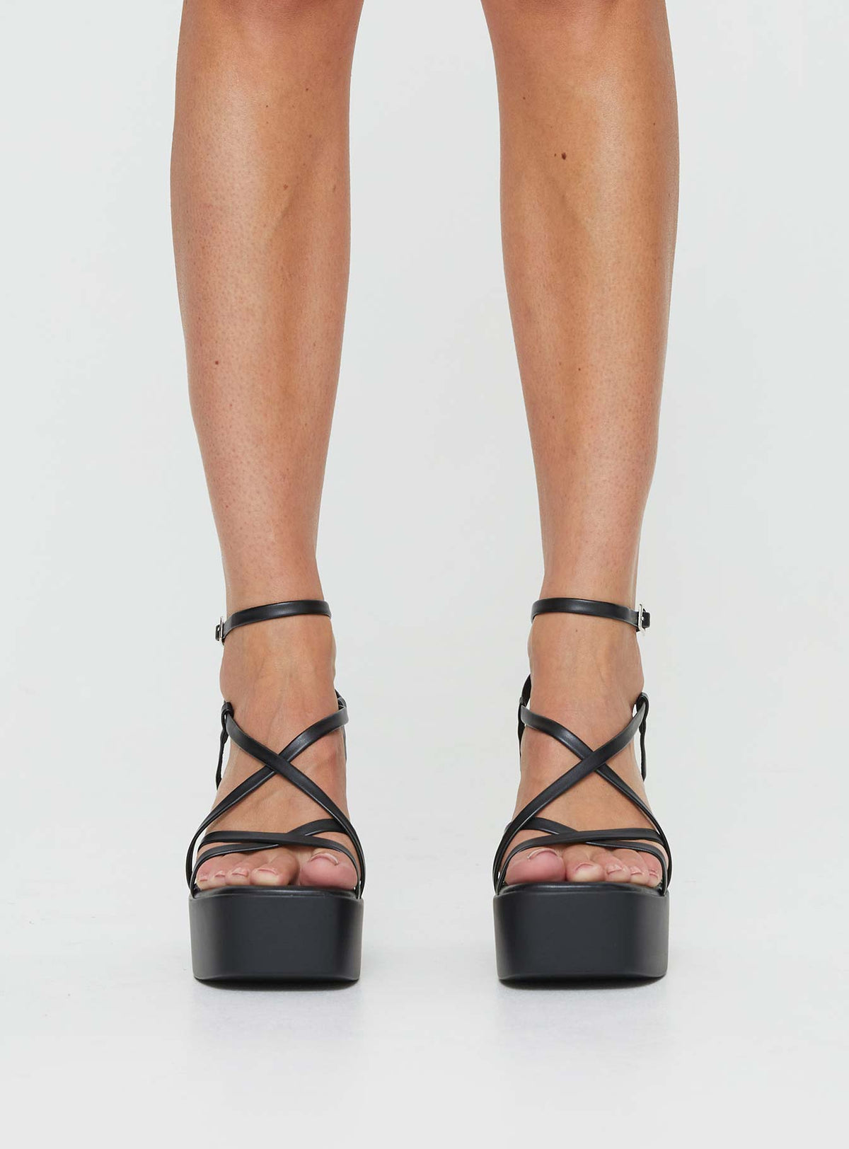 Heels Platform style, open toe, flared block heel Faux leather material, square open toe, thin upper straps Thin Ankle Strap with Adjustable Buckle Fastening