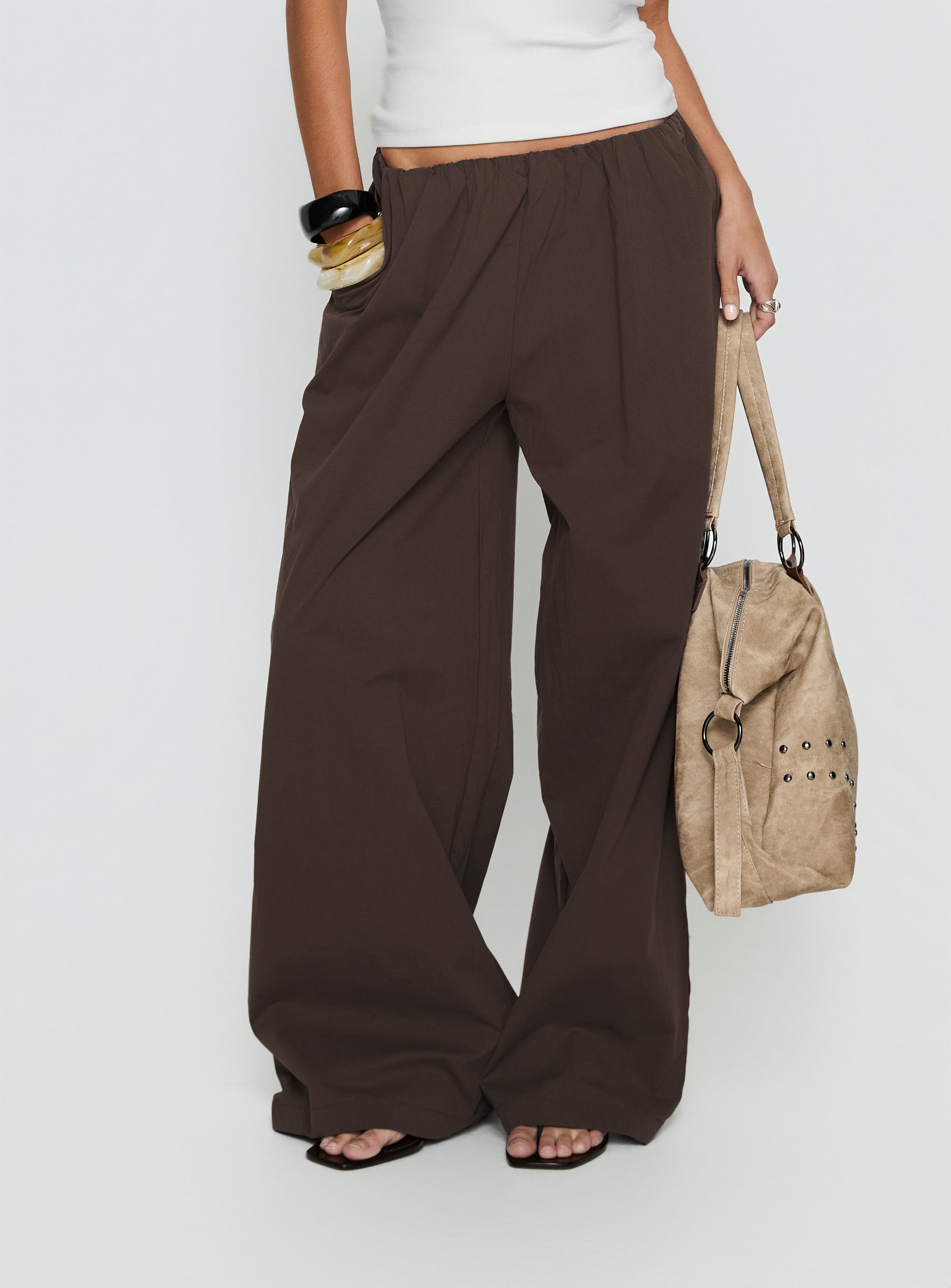 side view of model wearing Princess Polly Lunea Concealed Waistband Pants Brown Low Rise Pants 