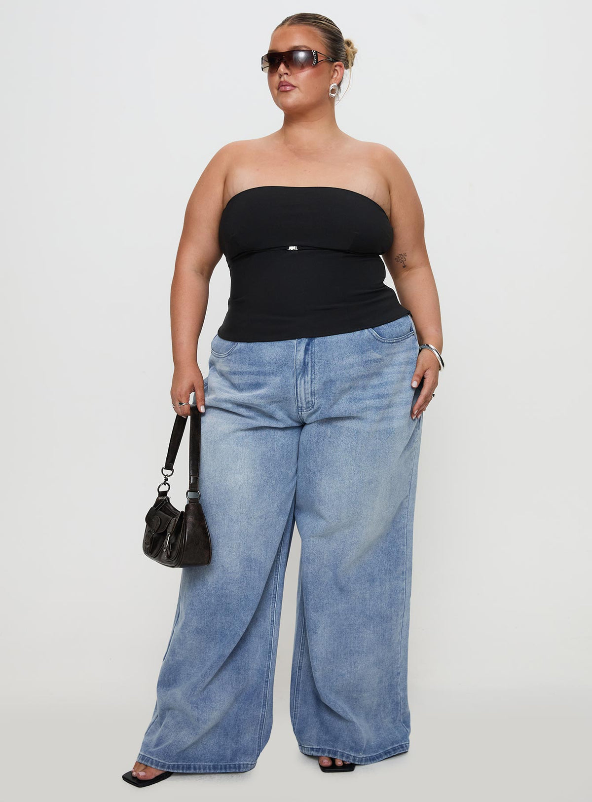 front view of model wearing Princess Polly Naylor Mid Rise Wide Leg Jeans Light Wash Denim Curve Mid Rise Jeans Jeans 