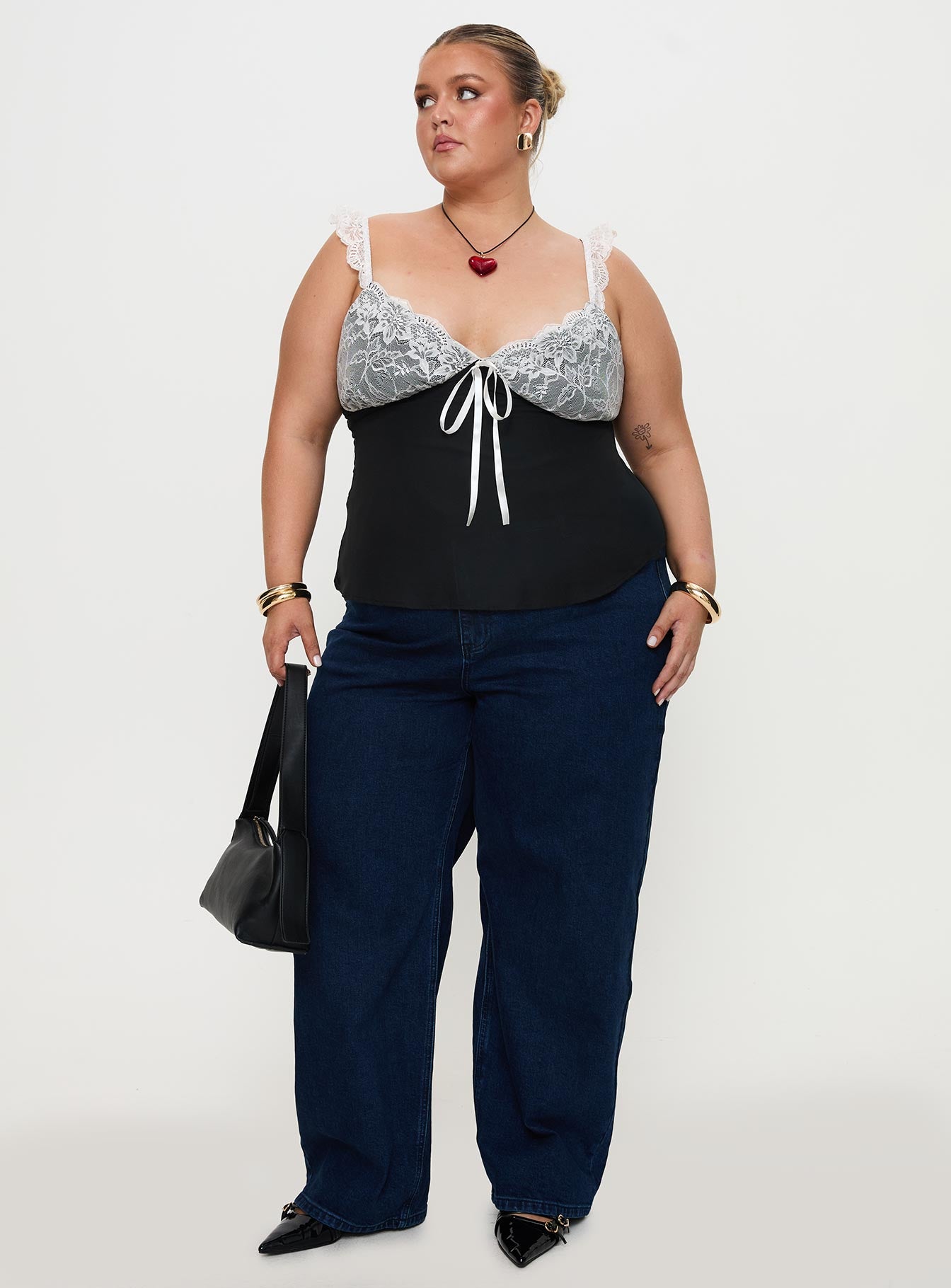 side view of model wearing Princess Polly Delvonte Top Black Curve Sleeveless Plunger 
