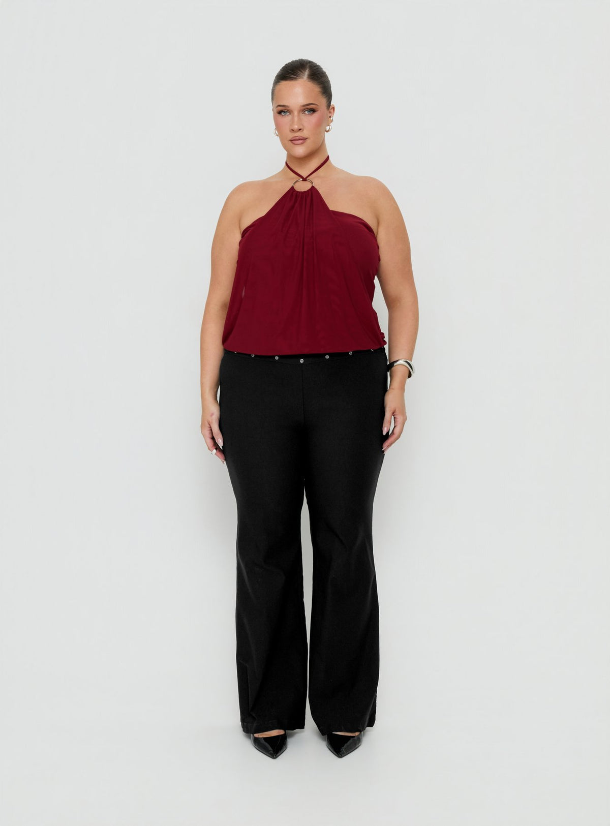 Showcasing the Yevina Eyelet Flare Pant Black Curve womens-regular-pants with mid-rise front view of model wearing Princess Polly