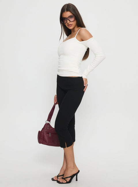 side view of model wearing Princess Polly Baseline Rib Capri Pants Black Tall Mid Rise Pants 