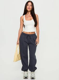 front view of model wearing Princess Polly Caspa Dream Fleece Oversized Ankle Cuff Jogger Navy High Rise Pants 