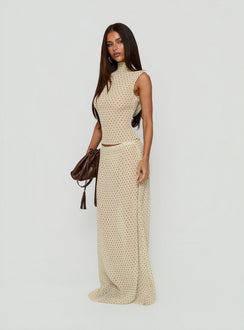 Crafted from premium fabric, the Ford Maxi Skirt Butter Chocolate Polka Dot in womens-skirts with a maxi length design side view of model wearing Princess Polly