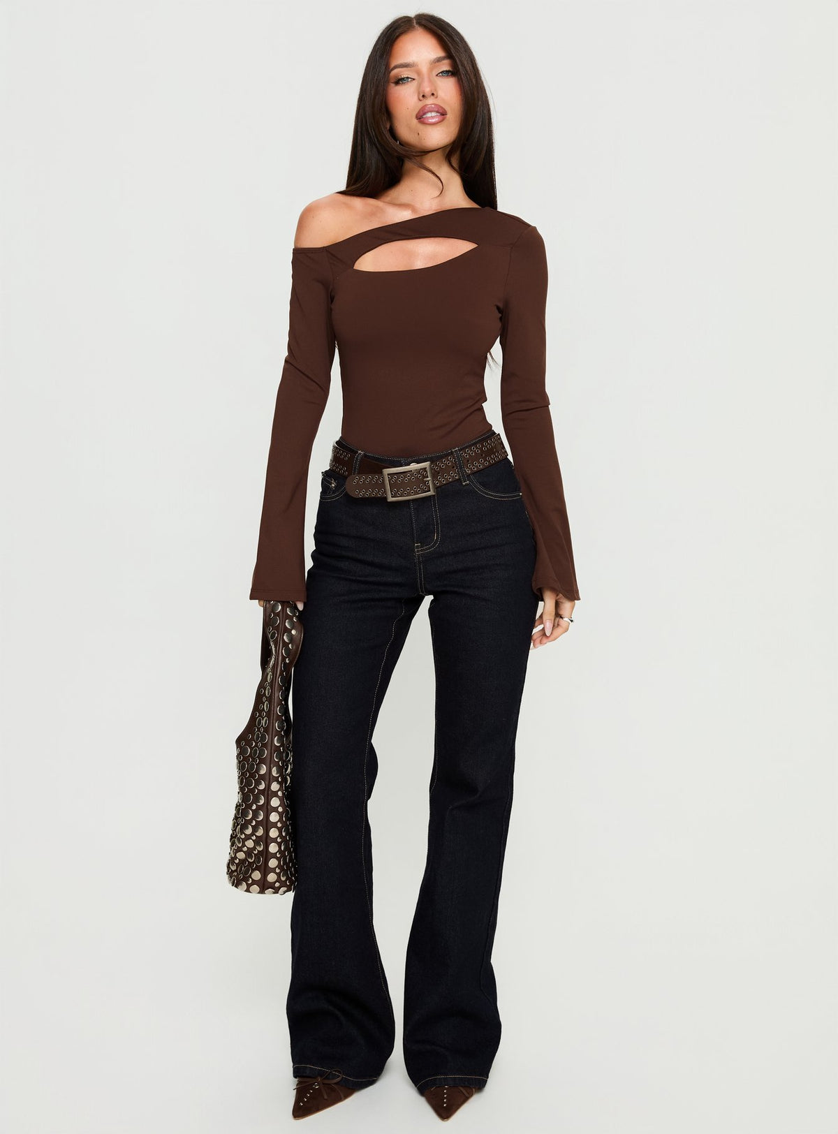 side view of model wearing Princess Polly Raissa Cut Out One Shoulder Bodysuit Brown Long Sleeve Tops 