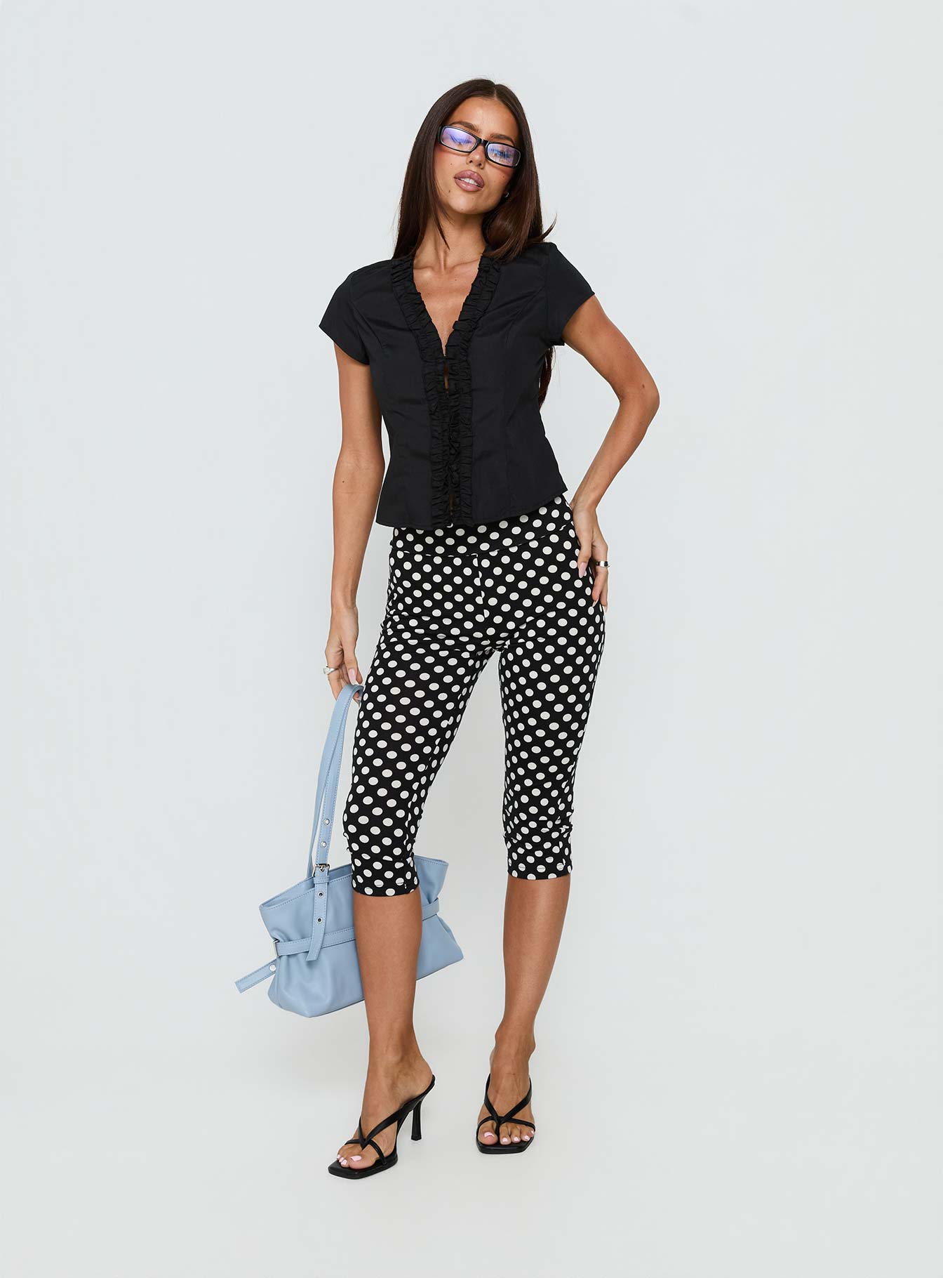 front view of model wearing Princess Polly Isadonna Capri Pants Black Polka Dot Mid Rise Pants 