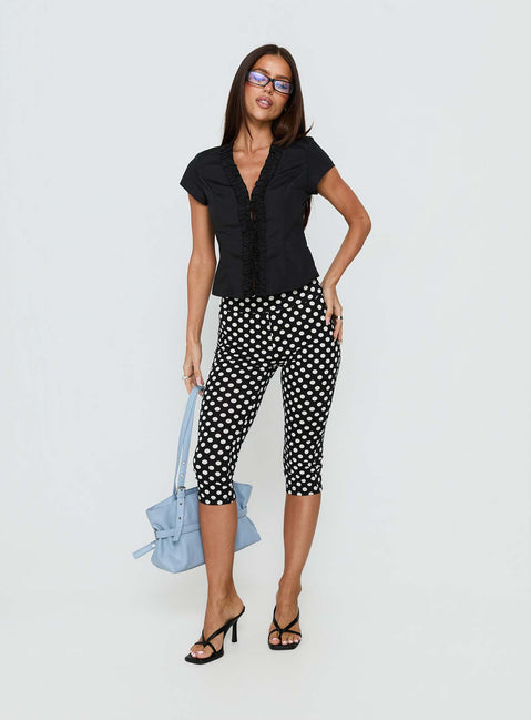 front view of model wearing Princess Polly Isadonna Capri Pants Black Polka Dot Mid Rise Pants 