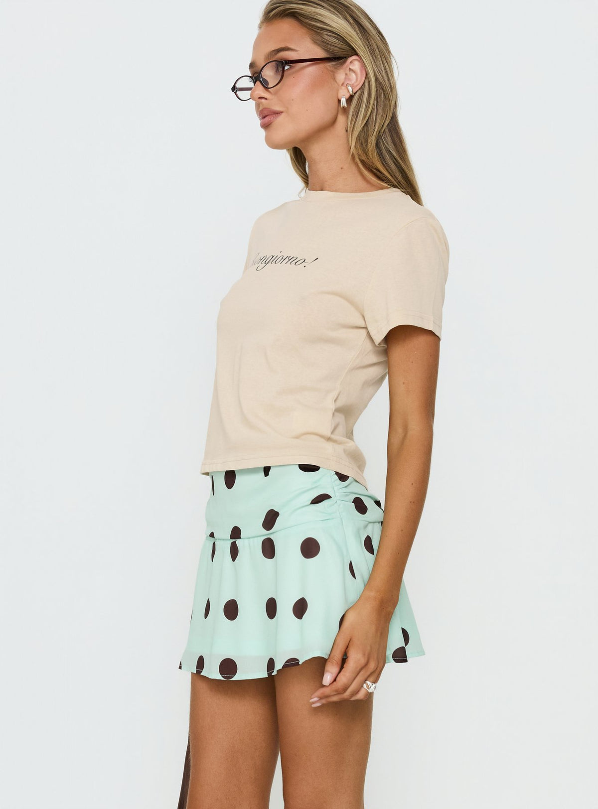   side view of model wearing Princess Polly Elicia Ruched Mini Skirt Mint / Chocolate Polka Dot Mini Skirts 
